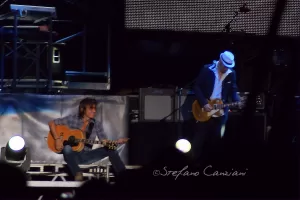 Luciano Ligabue – Concerto dal vivo con chitarra Luciano Ligabue - Due musicisti sul palco che suonano chitarra durante un concerto dal vivo