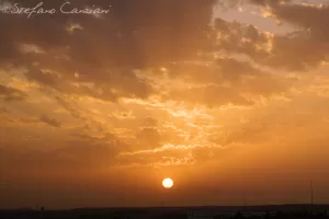 Tramonto suggestivo con nuvole e raggi di sole che si intrecciano sullo sfondo