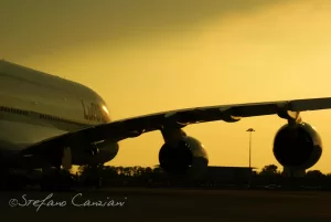 Aereo in volo con silhouette contro il cielo al tramonto